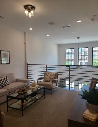 A cozy loft area with natural light, modern furnishings, and stylish decor, perfect for relaxation and entertaining.