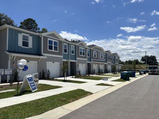 Street view Modern townhomes with pristine exteriors and garages in Tara Baywood by Lennar (Alachua, FL). Model now open.