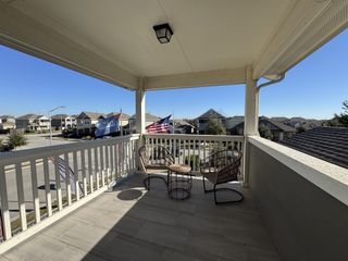 Street view A balcony with seating, overlooking the Blanco Vista community by Pacesetter Homes in San Marcos, TX.