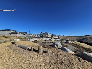 A picturesque park with playground and scenic landscape in Sunset Village: The Monarch Collection by Lennar (Erie, CO).