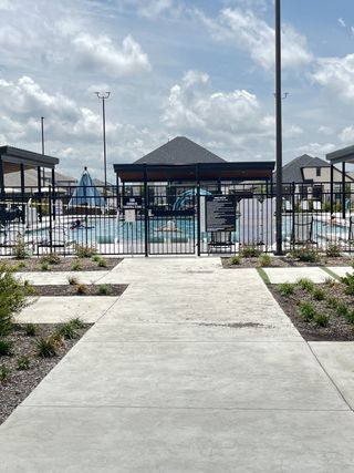 A welcoming community pool area with shaded seating in Lakehaven by Trophy Signature Homes (Farmersville, TX).