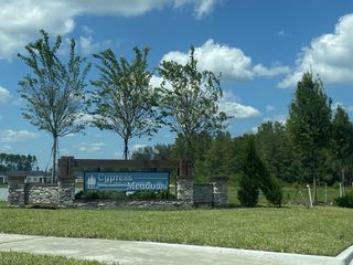 A welcoming entrance sign with lush greenery in Cypress Meadows - Signature Series by Meritage Homes (Jacksonville, FL).