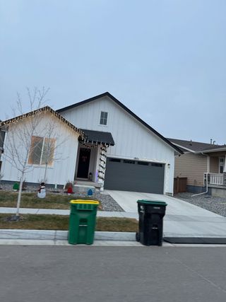 Charming white home with festive lights in Villages at Prairie Center by Richmond American Homes (Brighton, CO).