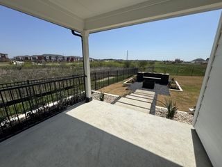 A serene backyard view with a sleek patio and landscaped garden.