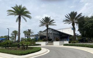 A modern facility with palm trees and landscaped grounds in Granville at eTown 38' by David Weekley Homes (Jacksonville, FL).