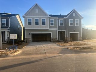 A modern two-story home with stone accents and double garage in Carolina Springs: Designer Collection by Lennar (Apex, NC).