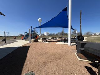 Community Amenities A vibrant park with a shaded picnic area and playground in Crosswinds by Milestone Community Builders (Kyle, TX).