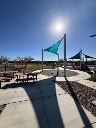 Community Amenities A vibrant community park with shade sails and picnic areas in The Palms Collection at The Trails at Tortosa by Century Communities (Maricopa, AZ).