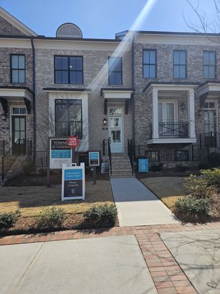 Elegant townhomes with classic brick facades in Towns on Thompson by The Providence Group, Alpharetta, GA.