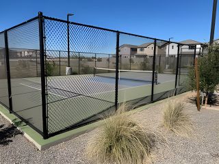Community Amenities A modern tennis court in Hawes Crossing: Reflection by Lennar, Mesa, AZ, enhanced by a desert landscape backdrop.
