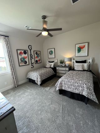 A cozy bedroom with twin beds, playful decor, and modern accent pieces.