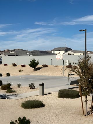 A community basketball court surrounded by landscaped desert terrain in Sunrise – Canyon Series by Landsea Homes (Surprise, AZ).