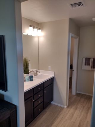 A contemporary bathroom with a sleek black vanity, stylish lighting, and modern decor accents.