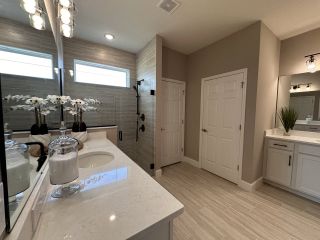 A modern bathroom with sleek fixtures, a spacious vanity, and elegant lighting, enhancing its sophisticated design.