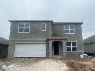 A newly built home with stylish siding and stone details in Mirada by D.R. Horton (San Antonio, FL).