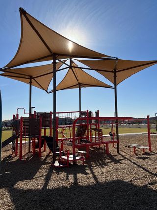 Community Amenities A vibrant playground with shade sails in Bentridge – Peak Series by Landsea Homes, Buckeye, AZ.
