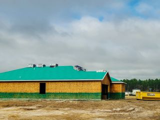 Street view A new construction with a green roof in progress at Kings Preserve by Breeze Homes, Jacksonville, FL.