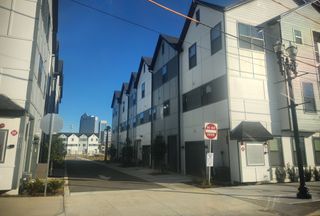A modern townhouse community with private garages and pedestrian-friendly streets in Johnson Commons by Breeze Homes (Jacksonville, FL).