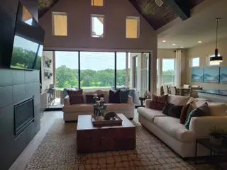 Model Home A cozy living area with plush sofas, large windows, and elegant decor. Scenic views create a serene ambiance.
