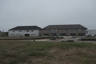 Street view Modern townhouse buildings in Painted Tree - Village District by CB JENI Homes, set in McKinney, TX.