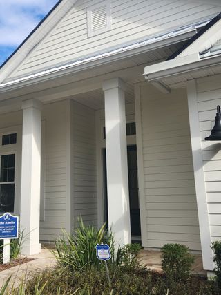 A grand home entrance with classic white columns in Amelia National Country Club by Riverside Homes (Fernandina Beach, FL).