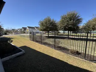 Street view Charming tree-lined street with modern homes in Easton Park by Newmark Homes (Austin, TX).