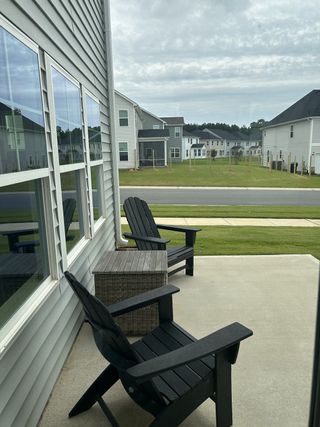 Charming patio with Adirondack chairs, perfect for relaxing.