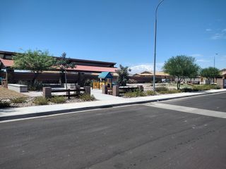 Street view A picturesque community with desert landscaping in Bridle Park at Alamar by Richmond American Homes (Avondale, AZ).