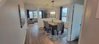 A cozy dining area with natural light, featuring a stylish table and elegant chairs.