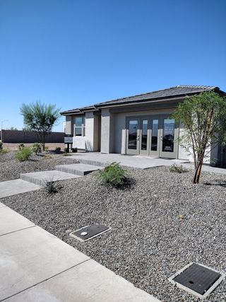 Street view A modern home with clean lines and desert landscaping in Retreat at Aloravita by Ashton Woods (Peoria, AZ).