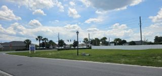 Scenic street view in Brookhaven by Adams Homes, showcasing open green spaces in Ocala, FL.