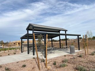 A charming community park with shaded seating area in Solstice at Terraza by Tri Pointe Homes (San Tan Valley, AZ).