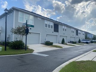 Modern townhomes with spacious garages on a well-kept street in West End at Town Center by ICI Homes (Ponte Vedra, FL).