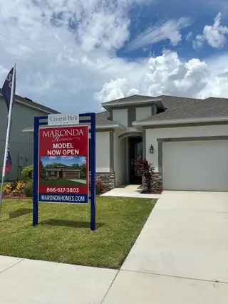 Charming modern home with stone accents and manicured lawn in Central Park by Maronda Homes (Port St. Lucie, FL).