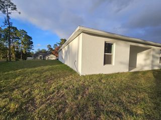 A modern white home with a spacious yard in Marion Oaks by Century Complete (Ocala, FL).