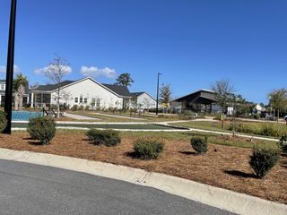 A charming community entrance with well-maintained landscaping at Encore - Restore at Carolina Park by David Weekley Homes (Mount Pleasant, SC).