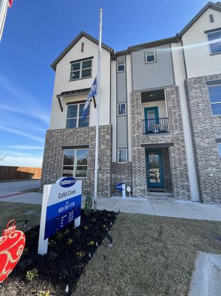 A modern brick townhouse in Collin Creek by Mattamy Homes, featuring a neat entrance and landscaped surroundings (Plano, TX).