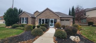 Street view A charming brick home with a well-landscaped front yard in the Davis Ranch community by Pulte Homes (San Antonio, TX).