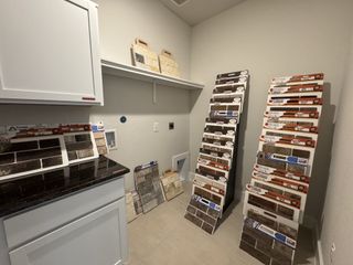 A selection room showcasing diverse brick samples and cabinet finishes, perfect for choosing home interiors.