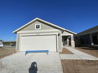 Street view A charming single-story home in Turner's Crossing by Meritage Homes (Buda, TX) featuring a modern farmhouse design, covered entryway, and a two-car garage.