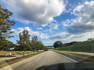 Scenic drive through lush landscapes in Hidden Ridge: Estate Collection by Lennar (Groveland, FL).
