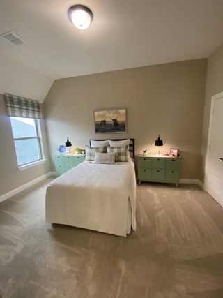 A serene bedroom with neutral tones, soft lighting, and rustic green nightstands, offering a peaceful retreat.