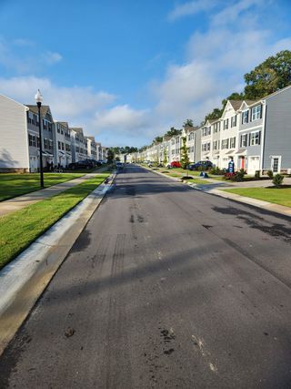 Street view Charming townhomes line a serene street in Pearces Landing Single Family Homes by Ryan Homes (Zebulon, NC).