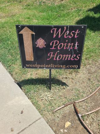 A West Point Homes sign on a grassy spot in Riverdance community by West Point Homes in Keller, TX.