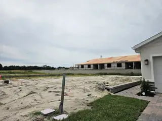 A developing site with new construction in Hammock Oaks Villas by Ryan Homes, Lady Lake, FL, showcasing future potential.